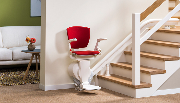 Un monte-escalier destiné aux utilisateurs de fauteuils roulants sur le côté intérieur de l'escalier. Un monte-escalier convient à un utilisateur de fauteuil roulant s'il peut effectuer le transfert du fauteuil roulant au siège du monte-escalier.